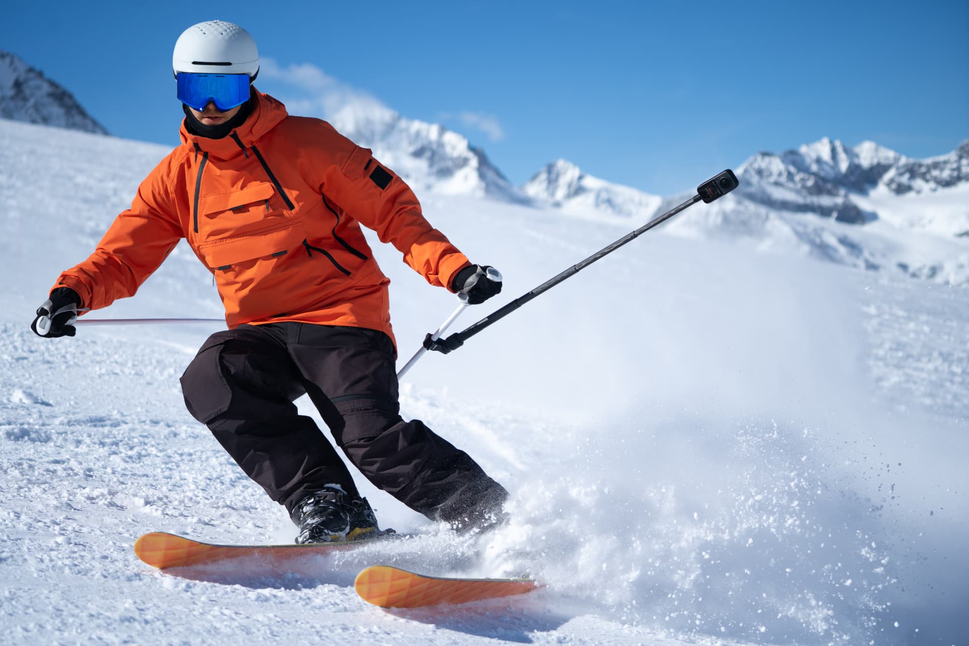 Skier carving through powder snow filming with an X6